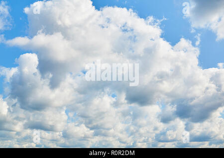 Wavy, porous curly clouds on the blue sky. Nature background. Stock Photo