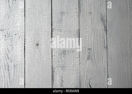 Highly detailed natural wooden planks painted in white color with craquelure effect. Textured white and grey aged background with vertical layout and  Stock Photo