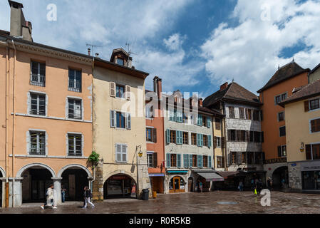 Street view of the beautiful town of Annecy in France showing a medieval urban fabric with arched shopping on the ground floors. Stock Photo