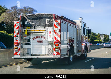 Ocotber 7, 2018 Menlo Park / CA / USA - Back view of Fire Engine driving on the freeway in south San Francisco bay area Stock Photo