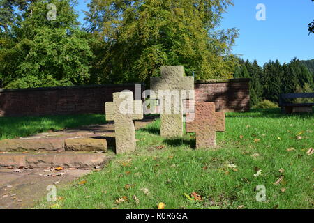 View towards the sand stone Cross at the entrance at the forest cemetery of one German Second World War military cemetery in Reimsbach an der Saar. Stock Photo