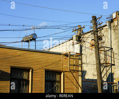Old retro style wooden pole with many electric supply wires or cables for telephone communication Stock Photo