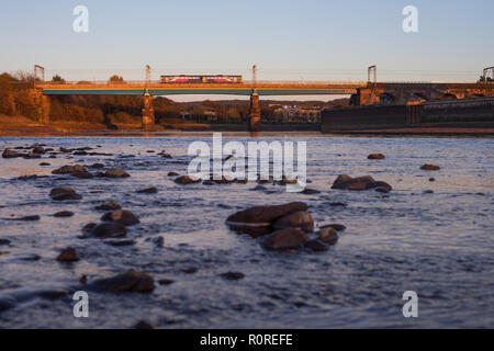 A Arriva Northern Rail class 142 pacer train crosses the viaduct over the river lune at Lancaster on the west coast main line. Stock Photo