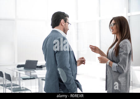 businessman and businesswoman discussing something in the new office Stock Photo