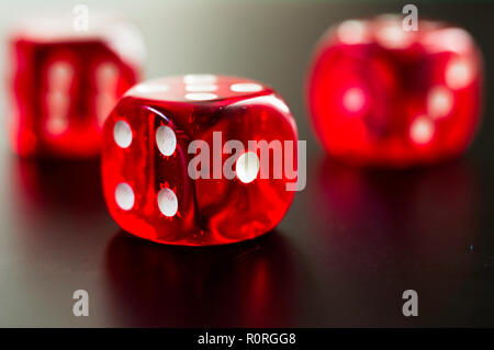 detail of three red dice on black background Stock Photo