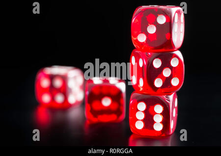 detail of five red dice on black background, with the numbers three, five, six, one, and four. Stock Photo