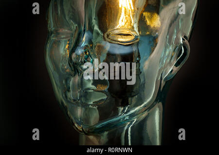 Bright lightbulb inside glass head for creative thoughts and ideas concept Stock Photo