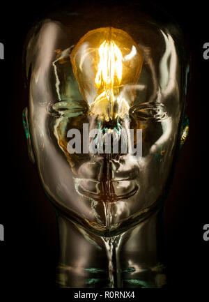 Bright lightbulb inside glass head for creative thoughts and ideas concept Stock Photo