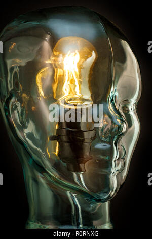 Bright lightbulb inside glass head for creative thoughts and ideas concept Stock Photo