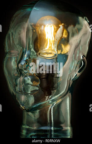 Bright lightbulb inside glass head for creative thoughts and ideas concept Stock Photo