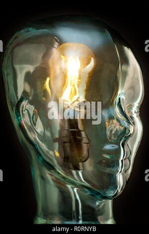 Bright lightbulb inside glass head for creative thoughts and ideas concept Stock Photo