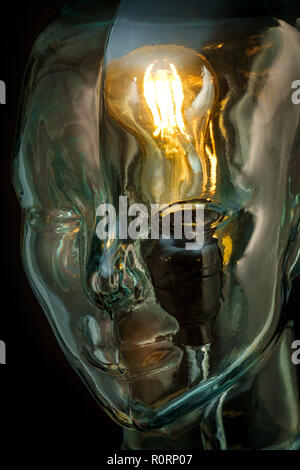 Bright lightbulb inside glass head for creative thoughts and ideas concept Stock Photo