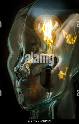 Bright lightbulb inside glass head for creative thoughts and ideas concept Stock Photo