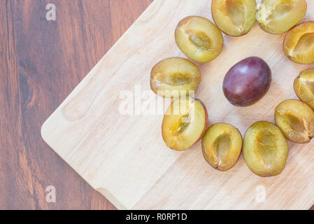 Fresh plums on a wooden chopping board Stock Photo