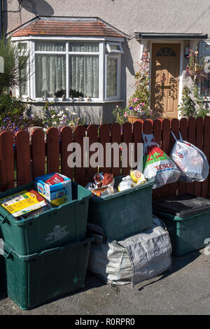 General view of recycling bins and bags of waste  outside a house on a residential street in Mochdre, Wales, as Conwy council introduce a scheme to co Stock Photo