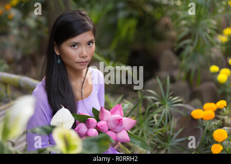 Young Woman in an Ao Dai Dress Holding a Bouquet of Lilies · Free Stock  Photo