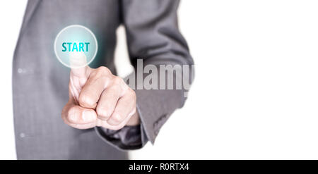 Businessman in gray suit pushing start button on touch screen interface to begin his business and success. Stock Photo