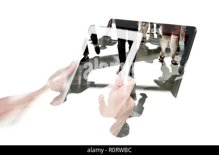Double exposure people walking and hands holding white tablet pc and laptop. Representing modern urban life with connection and communication technolo Stock Photo