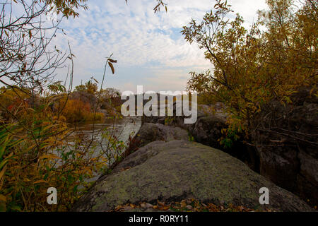 autumn trees on the rocky shore of the river Stock Photo