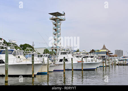 Part of the Destin commercial charter fishing fleet or boats along the Gulf coast in the Florida panhandle at Harbor Walk Marina, Destin Florida USA. Stock Photo