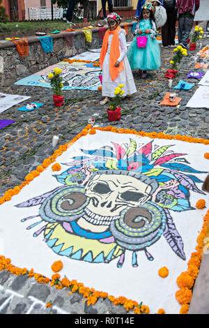 Dead of the Dead sand paintings on display outside the San Juan de Dios Church during the Dia de Muertos festival in San Miguel de Allende, Mexico. The multi-day festival is to remember friends and family members who have died using calaveras, aztec marigolds, alfeniques, papel picado and the favorite foods and beverages of the departed. Stock Photo
