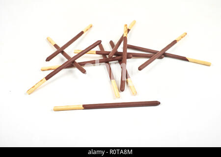 Biscuit sticks in chocolate coating on white background. Stock Photo