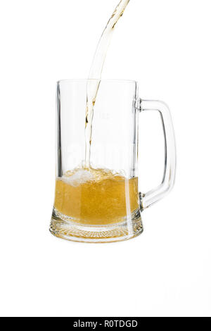 pouring light beer in a glass on an isolated white background Stock Photo