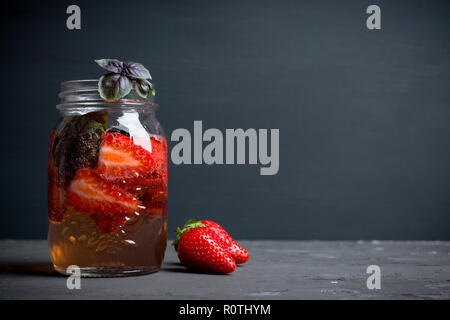 Fresh cocktail with strawberry and basil in glass. Shallow depth of field. Stock Photo