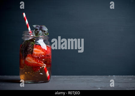 Fresh cocktail with strawberry and basil in glass. Shallow depth of field. Stock Photo