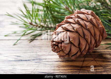 Pine cones and spruce branches on wooden background. Selective focus.Copy space. Stock Photo