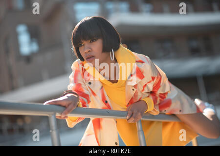 Newfangled contemptuous chick awkwardly posing during photoshoot Stock Photo