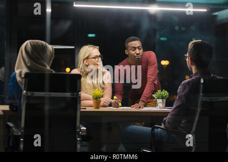 business colleagues, overwork, deadline and people concept -  working late at night in office Stock Photo