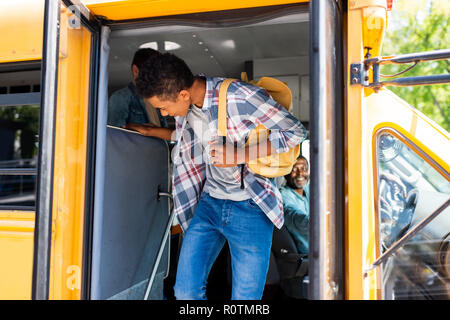 african american student walking out of school bus Stock Photo