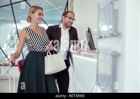 Stylish elegant wife standing near her successful prosperous man Stock Photo