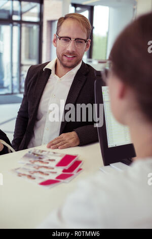 Businessman wearing suit and glasses checking in the hotel Stock Photo