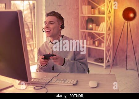 Teenager playing video battle games at home Stock Photo