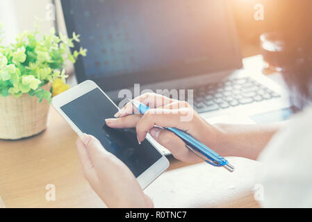 Business woman hand holding smartphone and finger touching the screen. Connection communication technology concept. Stock Photo