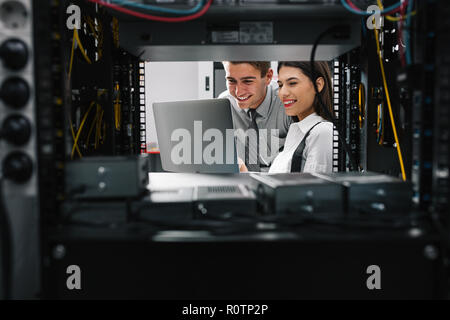 Two IT Engineers in Data Center, Server Room Stock Photo