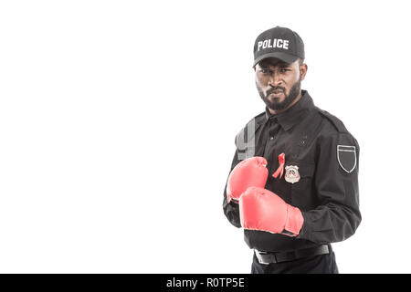 serious african american police officer with boxing gloves isolated on white, fighting aids concept Stock Photo