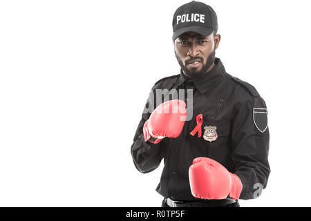 grimacing african american police officer with boxing gloves isolated on white, fighting aids concept Stock Photo