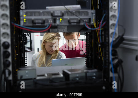 Two IT Engineers in Data Center, Server Room Stock Photo