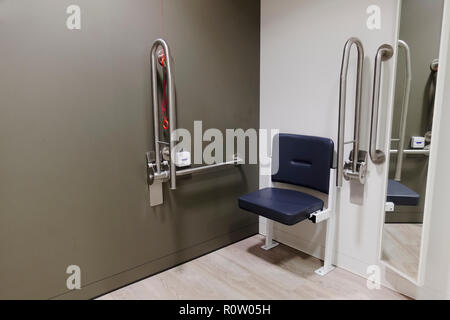 Disabled changing room with grab rails and seat doc m pack in shop store  uk Stock Photo