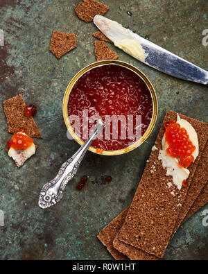 red caviar int tin with crispbreads and butter Stock Photo