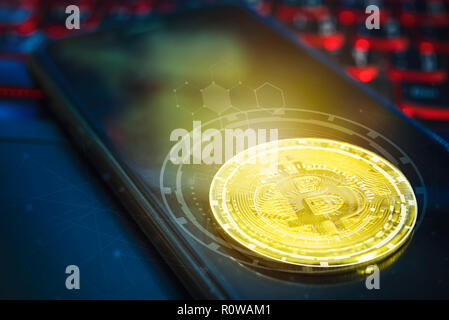 Bitcoin concept. Golden bitcoin on empty mobile screen on laptop with technology icons and free space background. Picture for add text message. Backdr Stock Photo