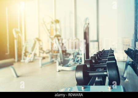 Fitness and healthy background concept. Dumbbells with blurred gym or sport  club background at sunset. Picture for add text message. Backdrop for desi  Stock Photo - Alamy