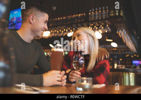 Couple having drinks in restaurant Stock Photo
