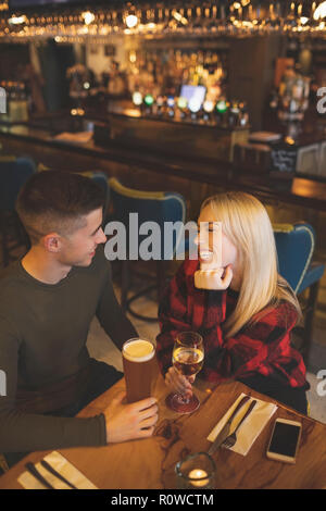 Couple having drinks in restaurant Stock Photo