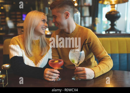 Couple having drinks in restaurant Stock Photo