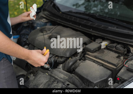 Woman checking a car during breakdown Stock Photo