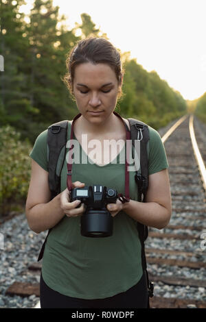 Woman reviewing photos on digital camera Stock Photo